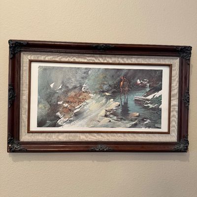 Framed nature print depicting deer standing in a misty stream, housed in an ornate dark wood frame with a fabric liner.
