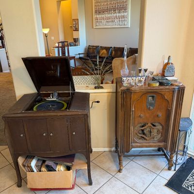 Vintage Victor Victrola hand-crank phonograph cabinet alongside an antique RCA floor standing console radio.