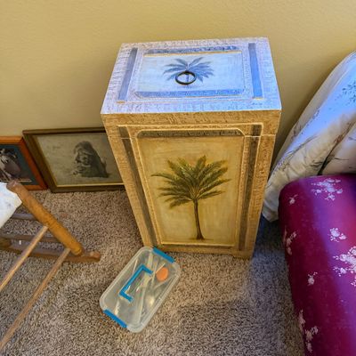 Hand-painted tropical-style tall storage hamper or cabinet featuring palm tree motifs and a ring pull lid.
