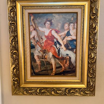 Classical-style framed art print depicting Diana the Huntress with her maidens and hounds, housed in an ornate carved gold-tone frame...