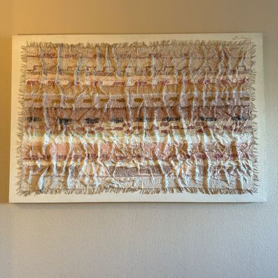 Large mid-century style dimensional textile wall hanging mounted on a white canvas, featuring a ruched weave in earthy beige, brown, and...