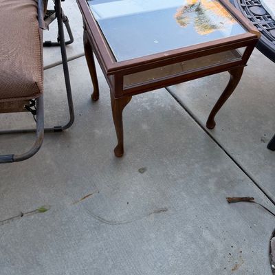 Vintage wood display end table featuring glass panels and cabriole legs.