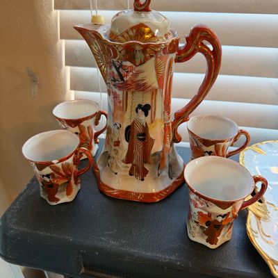 Vintage Japanese Kutani porcelain tea set including a tall covered teapot and four matching small teacups, featuring hand-painted geisha...