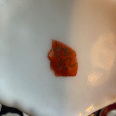 Detail shot showing the maker's mark on the underside of a white ceramic or porcelain dish.