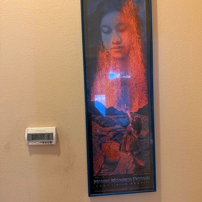 Framed 2005 Merrie Monarch Festival poster featuring volcano and hula art, set in a narrow blue frame.