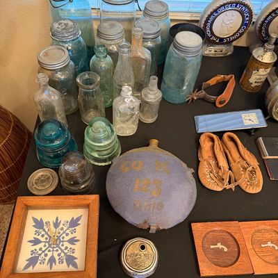 Collection of vintage collectibles including aqua glass canning jars, glass insulators, small bottles, a Civil War style canteen marked...