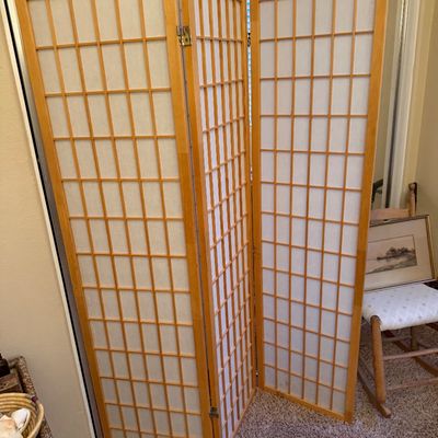 Four-panel Japanese shoji room divider screen with light wood frame and rice paper inserts.