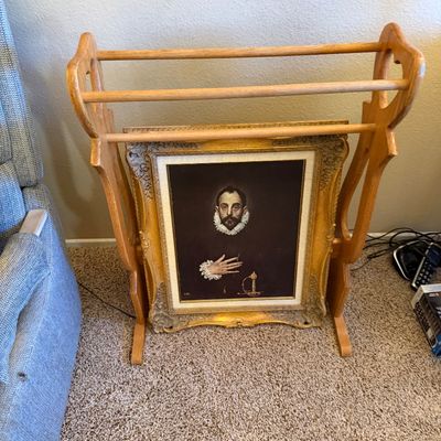 Freestanding wooden quilt or blanket rack with a framed reproduction painting of El Greco's 'The Nobleman with his Hand on his...