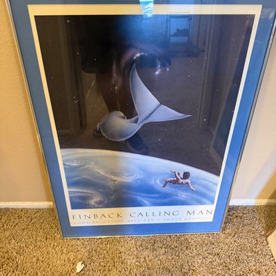 Framed vintage 'Finback Calling Man' art poster from Ahava Graphics, featuring a surreal space scene in a blue mat and...