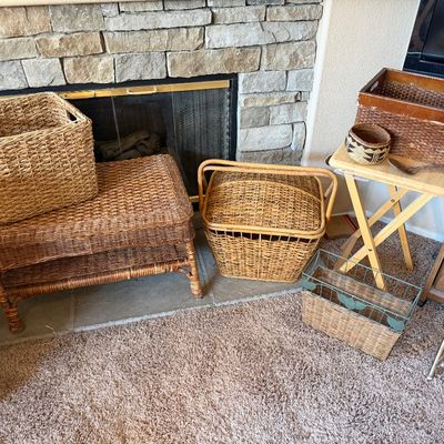 Collection of woven baskets and organization pieces, including a two-tier wicker bench, picnic basket, and wire-framed magazine rack.