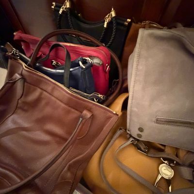 Assortment of leather and suede women's handbags, including a tan Dooney & Bourke bag with duck fob, a brown leather tote, and...