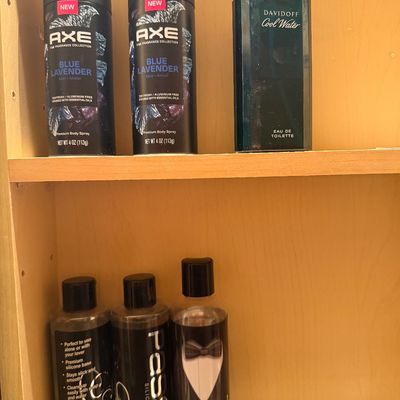 Sale Photo Thumbnail #109: Collection of men's personal care items including Axe Blue Lavender body spray cans, Davidoff Cool Water eau de toilette, and Shibari Tuxedo and Passion silicone lubricants.