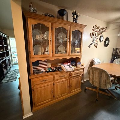 Traditional solid oak china cabinet hutch featuring leaded glass doors, lower drawers, and storage cabinets.