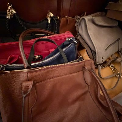 Collection of assorted modern women's leather handbags and totes in various colors, including brown, black, red, and grey.
