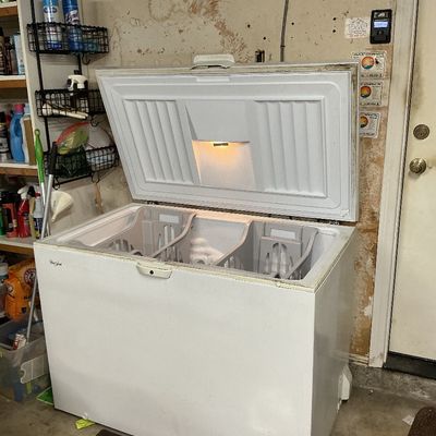Sale Photo Thumbnail #130: White Whirlpool chest freezer with open lid, internal light, and storage baskets, showing light wear.