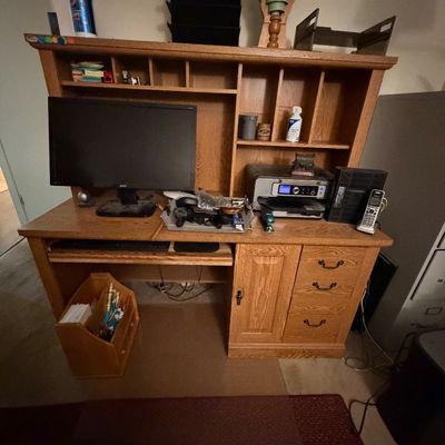 Sale Photo Thumbnail #101: Traditional wooden computer desk with an overhead hutch, featuring built-in cubbies, drawers, and a pull-out keyboard tray.