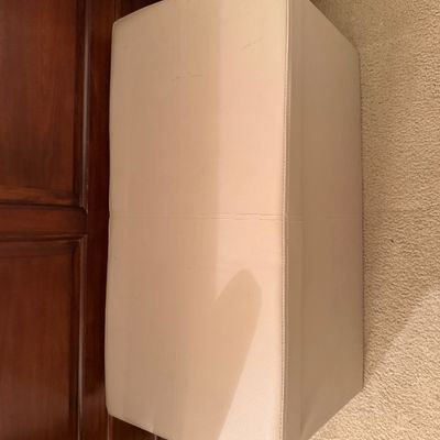 Rectangular beige faux leather storage ottoman bench with removable lid.
