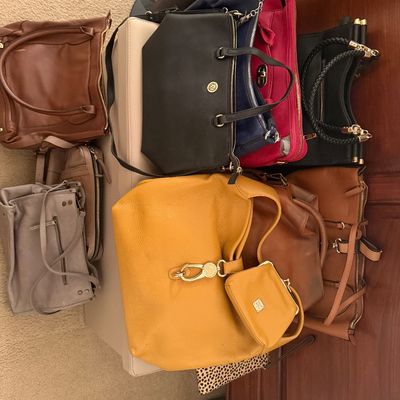 Collection of assorted women's leather handbags and shoulder bags in various colors including yellow, black, brown, red, and grey.