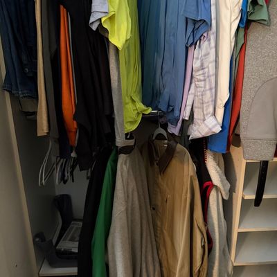 Sale Photo Thumbnail #113: Closet filled with assorted men's clothing including t-shirts, button-downs, sweaters, and jackets hanging on clothes racks.