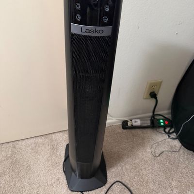 Sale Photo Thumbnail #115: Lasko ceramic tower heater in dark gray with digital control panel and front mesh grille.