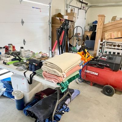 Sale Photo Thumbnail #32: A red Craftsman 150 PSI portable air compressor, wool camping blankets and camping supplies, coolers, and tools 
