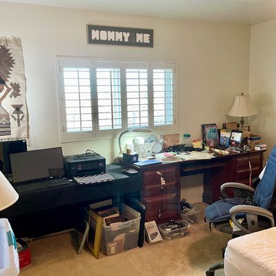 Sale Photo Thumbnail #16: Home office setup featuring a traditional dark wood executive desk, office chairs, computer equipment, lamps, and a woven tapestry on the wall
