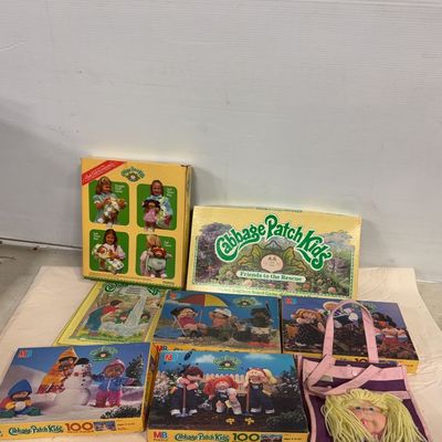 Collection of vintage 1980s Cabbage Patch Kids items, including boxed Milton Bradley puzzles, a Parker Brothers Friends to the Rescue...