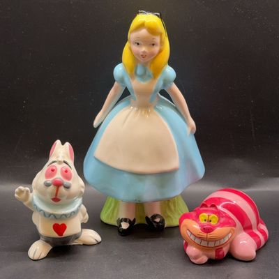 Set of vintage ceramic Alice in Wonderland figurines by Wade, featuring Alice, the White Rabbit, and the Cheshire Cat.