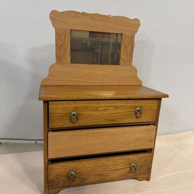 Vintage miniature oak dresser featuring three drawers, metal ring pulls, and an attached top mirror frame with carved details.