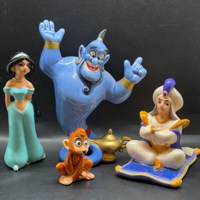 Set of Disney's Aladdin ceramic figurines featuring Princess Jasmine, the Genie, Abu, and Prince Ali on the Magic Carpet, appearing...