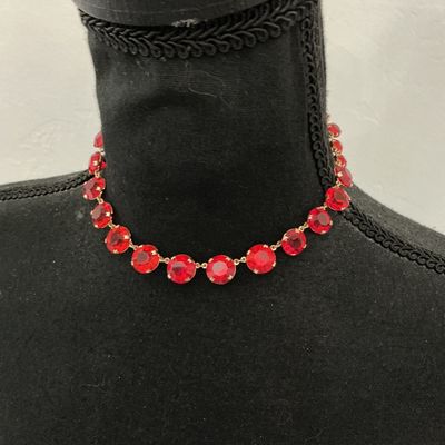 Sale Photo Thumbnail #204: Vintage gold-tone choker necklace featuring round, prong-set vibrant red rhinestones or glass crystals with decorative textured settings. Includes an adjustable hook closure with a rhinestone dangle tail. Appears to be in good vintage condition with all s