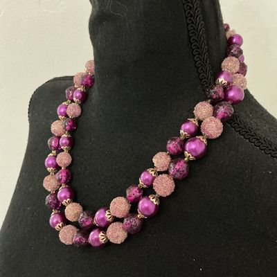 Sale Photo Thumbnail #179: A vintage double-strand beaded choker/necklace featuring a mix of vibrant fuchsia, deep purple, and textured pink "sugar" or frosted beads with filigree bead caps. Includes a decorative, matching pink cabochon box clasp marked "HONG KONG" on the back. Exc