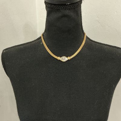 Sale Photo Thumbnail #212: Vintage gold-tone herringbone flat chain collar necklace featuring a central diamond-shaped focal point set with clear triangular rhinestones. Stamped S.A.L. © on the back (Swarovski America Limited mark used circa late 1970s to 1980s). Features a fold-o