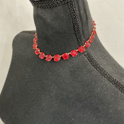 Sale Photo Thumbnail #208: Vintage gold-tone choker necklace featuring round, prong-set vibrant red rhinestones or glass crystals with decorative textured settings. Includes an adjustable hook closure with a rhinestone dangle tail. Appears to be in good vintage condition with all s