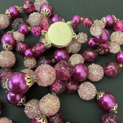 Sale Photo Thumbnail #180: A vintage double-strand beaded choker/necklace featuring a mix of vibrant fuchsia, deep purple, and textured pink "sugar" or frosted beads with filigree bead caps. Includes a decorative, matching pink cabochon box clasp marked "HONG KONG" on the back. Exc