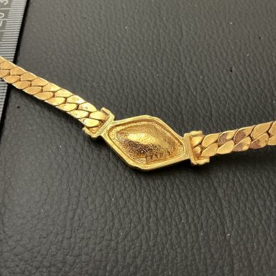 Sale Photo Thumbnail #221: Vintage gold-tone herringbone flat chain collar necklace featuring a central diamond-shaped focal point set with clear triangular rhinestones. Stamped S.A.L. © on the back (Swarovski America Limited mark used circa late 1970s to 1980s). Features a fold-o