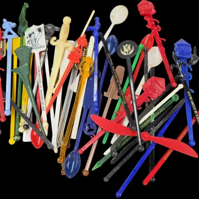 Sale Photo Thumbnail #11: Large collection of vintage plastic drink stirrers and swizzle sticks featuring various colors, designs, and promotional advertising text.