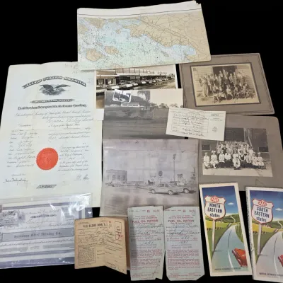 Sale Photo Thumbnail #124: Collection of vintage ephemera including a 1920s United States passport certificate, early 20th-century framed photographs, World War II rationing books, stock certificates, and AAA road maps.
