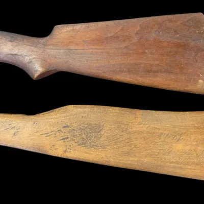 Sale Photo Thumbnail #75: Pair of vintage carved wooden gun stocks showing natural wood grain and wear.