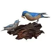 Sale Photo Thumbnail #18: Hand-carved and painted wooden bluebird figurine depicting an adult feeding a fledgling, mounted on a rustic wood base.