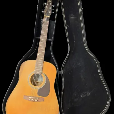 Sale Photo Thumbnail #25: Ovation acoustic guitar with a natural finish top, displayed inside its open black hard-shell case.