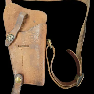 Sale Photo Thumbnail #76: Vintage U.S. military M3 tan leather shoulder holster, featuring embossed 'US' oval logo and brass hardware.