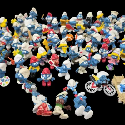 Sale Photo Thumbnail #84: Large collection of vintage Peyo Smurf PVC toy figurines featuring various characters, costumes, and accessories from the 1980s.