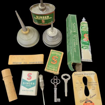 Sale Photo Thumbnail #102: Collection of vintage Singer sewing machine accessories, including oil cans, motor lubricant tubes, needle packages, keys, and a scissors sharpener.