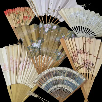 Sale Photo Thumbnail #78: Collection of vintage Asian-style folding hand fans featuring painted floral and metallic designs on paper and wood frames.