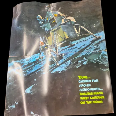 Sale Photo Thumbnail #106: Vintage Tang promotional poster celebrating the Apollo moon landing, featuring artwork of an astronaut and lunar module with fold creases.