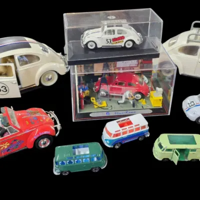 Sale Photo Thumbnail #85: Collection of die-cast model Volkswagen Beetles and buses, including several Herbie the Love Bug models, a Mini-Rama garage diorama, and novelty Volkswagen figures.
