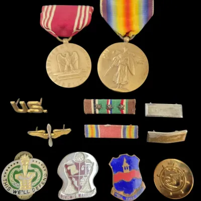 Sale Photo Thumbnail #108: Collection of World War I and II US military medals, ribbons, and insignia pins, including an Army Good Conduct Medal, World War I Victory Medal, and Army Air Forces insignia.