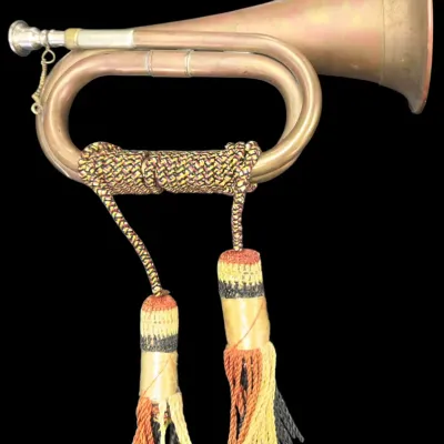 Sale Photo Thumbnail #140: Vintage brass military bugle with decorative braided rope wrapping and hanging tassels.
