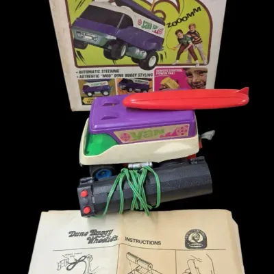 Sale Photo Thumbnail #14: Vintage Remco motorized remote-controlled Dune Buggy Wheelies Van toy with surfboard accessory, original wired controller, instruction sheet, and original box, circa 1970s.